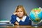 School concept. crying girl with astonished or doubt expression sitting at desk