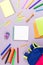 School concept flat lay. Kid backpack, notebook, markers on wooden desktop