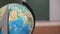School concept, globe and ruler on the background of the school board in the classroom. School or college atmosphere