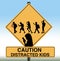 A school crossing sign includes silhouettes of children using cell phones in this illustration