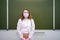 A school doctor in a medical mask stands with an anxious face at the blackboard, copy space. School quarantine education concept