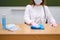 School doctor wearing a medical mask wipes the table with a rag. School quarantine education concept