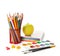 School equipment with pencils, paints , brushes and apple on white. Back to school concept