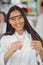 School girl experimenting with piece of glass in laboratory at school