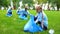 School girl with group of eco volunteers picking up litter park, saving nature