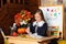 school girl on lesson in classroom. Back to school. A cute hardworking child is sitting at table in school.