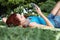 School girl at the park with smart phone and earphone