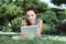 School girl at the park with tablet and earphone