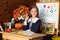 school girl raising his hand in classroom. Back to school. A cute hardworking child is sitting at table in school.