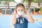 School Girl wearing mouth mask against air smog pollution in Bangkok city, Thailand