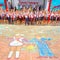 School graduates, written on the pavement, amid a jubilant crowd of graduates