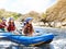 School holidays. Group of children kayaking on river