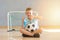 School kid with blue mask and soccer  ball in a physical education lesson. Safe back to school during pandemic concept. Social dis