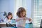 School kid doing homework. Pupil gets ready for school. Portrait of child at school at class workplace.