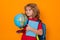 School kid with globe and book. Smart clever nerd. Caucasian blonde school boy kid pupil student going back to school