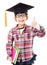 school kid in graduation cap with thumb up