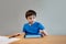 School Kid learning online class room at home, Child using tablet for homework, Young boy studying online video call, E-learning