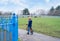 School kid learns to ride a bike in the Park, Portrait of a lonely little boy on bicycle alone on the grass fields, Sad Child in