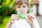 School kid playing with Tri Fidget Hand Spinner outdoors