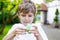 School kid playing with Tri Fidget Hand Spinner outdoors