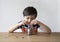 School Kid putting money sterling pound coins into clear jar, Child counting his saving money, young boy holding coin, Children