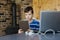 School kid using laptop while doing schoolwork at home. Homeschooling. School from home