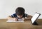 School Kid using pen drawing on paper, A boy doing home work sitting with mock up tablet, Child using digital pad searching