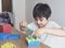 School kid using plastic block counting number, Child boy studying math by colour stack box, Dienes or Montessori classroom