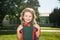 School, kids education concept. Child with rucksacks standing in the school park. Pupil with backpacks outdoors.