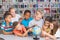 School kids looking at globe in library