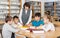 School kids studying with female teacher