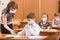 School kids and teacher with protection mask against flu