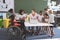 School kids using digital tablet while teacher interacting with students at school