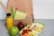 School lunch box with sandwich, vegetables, water, fruits, backpack with school objects