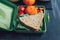 School lunch boxes with sandwich and fresh vegetables, nuts and fruits