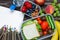 School lunch boxes with sandwich, fruits, vegetables and bottle of water with colored pencils and empty copybook