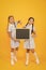 School news. True information. Little girls hold writing surface yellow background. Children and chalkboard for writing