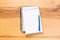 School notepad and pen on the wooden desk. spiral notepad on a tableschool notepad and pen on the wooden desk. spiral notepad on a