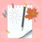 School notepad with pencil and autumn leaf