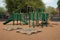 school playground with climbing ropes, monkey bars, and benches