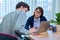 School psychologist supporting guy student, sitting in office of educational building