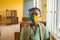 School pupil`s sitting in class, wearing face masks, and observing physical distancing