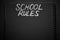 School rules word written on a notepad with blank space. Blank black notepad background