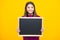 School sales board. Cheerful teenage girl kid hold blackboard chalkboard with copy space.