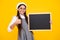 School sales board. Cheerful teenage girl kid hold blackboard chalkboard with copy space. Happy face, positive and