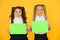 School socialization. Girls school uniform hold poster. Back to school concept. Schoolgirls show poster. Social poster