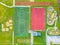 School sports ground with football stadium, jogging tracks around. basketball, volleyball, tennis courts. aerial photo, top view