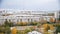 School stadium inside a block of old apartment buildings against the backdrop of a television tower. Sleeping urban areas. Autumn