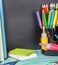 School stationery laid on a background of chalkboard