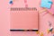 School stationery supplies accessories on pink background, flat lay, top view.